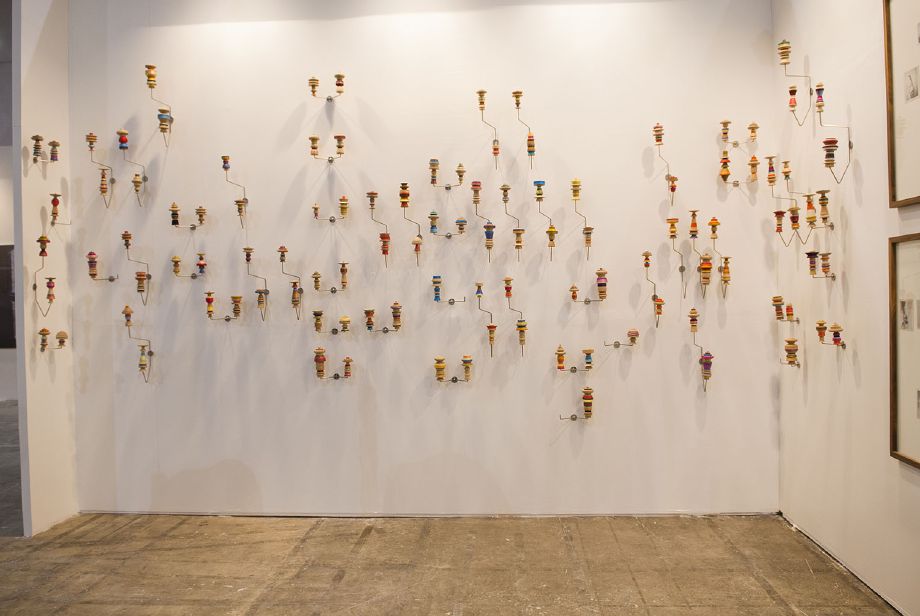 Edgar Orlaineta. Hang-them-all, 2014 Stainless steel, turned wood and color thread Dimensions variable (60 racks with 120 Katsinas)