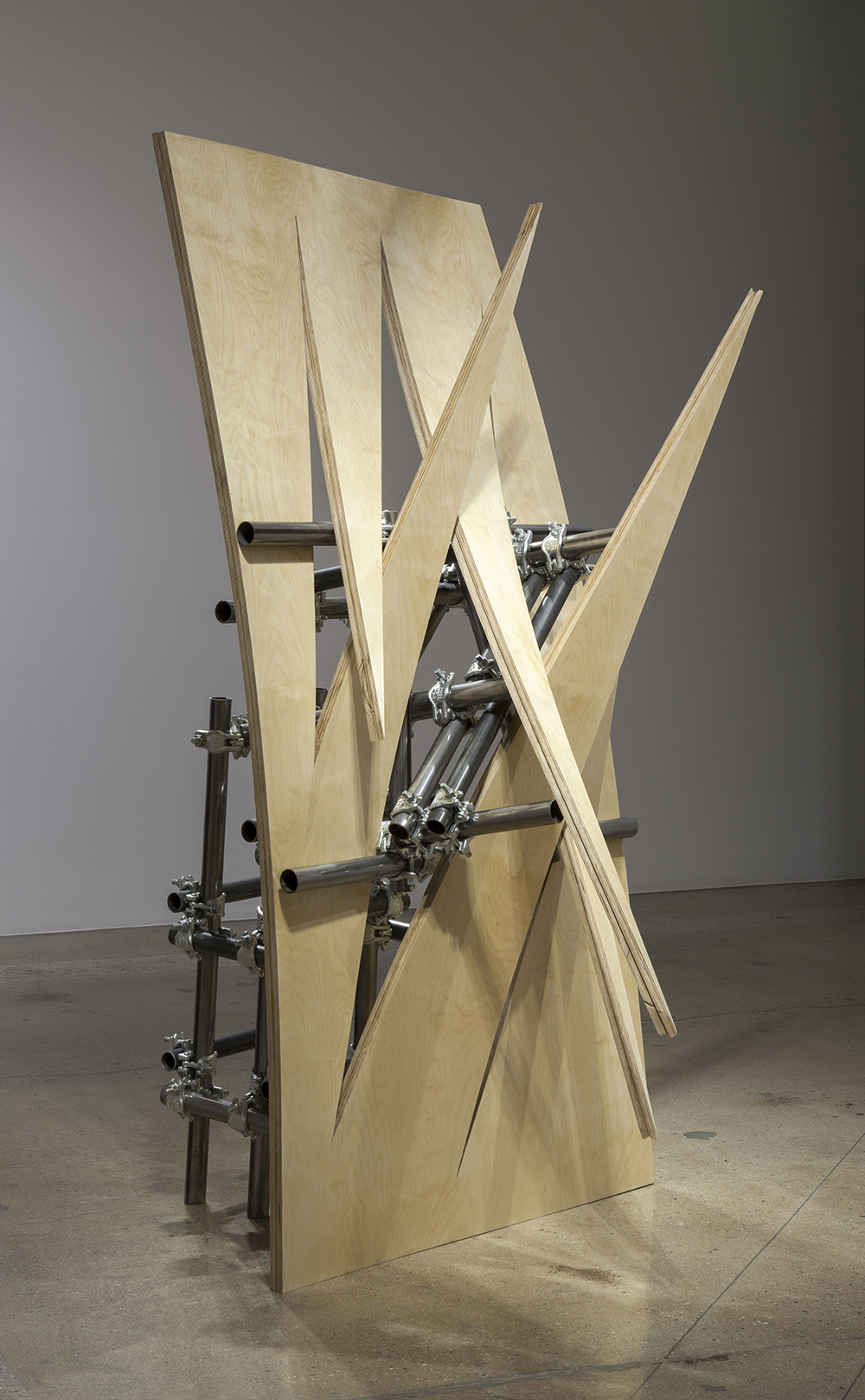 luciana lamothe, sculpture, women sculptor, installation, free function, form over function, tension, plywood, iron pipes, couplers,