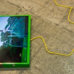 <em>off top</em>, 2017. Digital video, monitor, spray paint, Model Magic ®, sticker and ink on powder coated steel and extension cord, Length: 3 minutes, 2 seconds, 27 x 45 x 4 inches