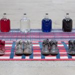 Amanda Ross-Ho and Diedrick Brackens. <em>Untitled Floor Arrangement (300 bucks would save my life)</em>, 2017. Handwoven cotton rugs, glass jugs, Procion dyes, Nike Dunks, and Reebok Pumps, 12 1/4 x 64 1/2 x 48 inches