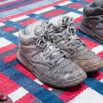 Amanda Ross-Ho and Diedrick Brackens. <em>Untitled Floor Arrangement (300 bucks would save my life)</em>, 2017. Handwoven cotton rugs, glass jugs, Procion dyes, Nike Dunks, and Reebok Pumps, 12 1/4 x 64 1/2 x 48 inches. Detail