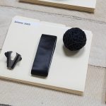 Amanda Ross-Ho and Diedrick Brackens. <em>Untitled Floor Arrangement (DRAMA)</em>, 2017. Handwoven cotton rugs, manilla folders, sensitive documents, labels, lint roller, black nitrile gloves, black vase, double fold bias tape (roll), ice scraper, plastic salsa bowl, oversized black paper clip, vinyl letters, material test with oversized black paper clip, material test with binder clip, camera case, three black owl glasses origin unknown, staple remover, satin seam binding, yarn ball, black mug, sunglasses, measuring spoon, DRAMA book, black scrunchie, and material test with oversized gold paper clip, 11 1/2 x 81 x 44 inches. Detail