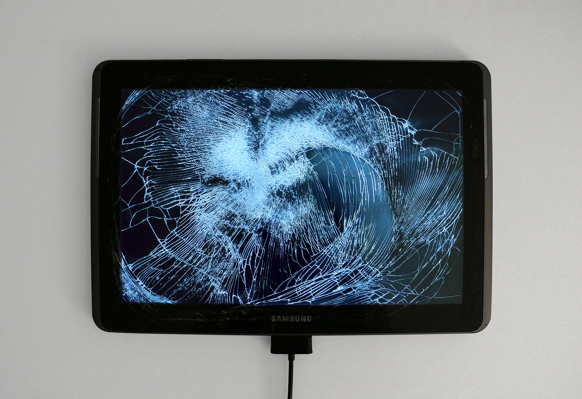 <em>Return of the Broken Screens (Samsung Galaxy Tab 2)</em>, 2016. Broken found tablet, video, 7 1/2 x 4 3/4 x 1/2 inches