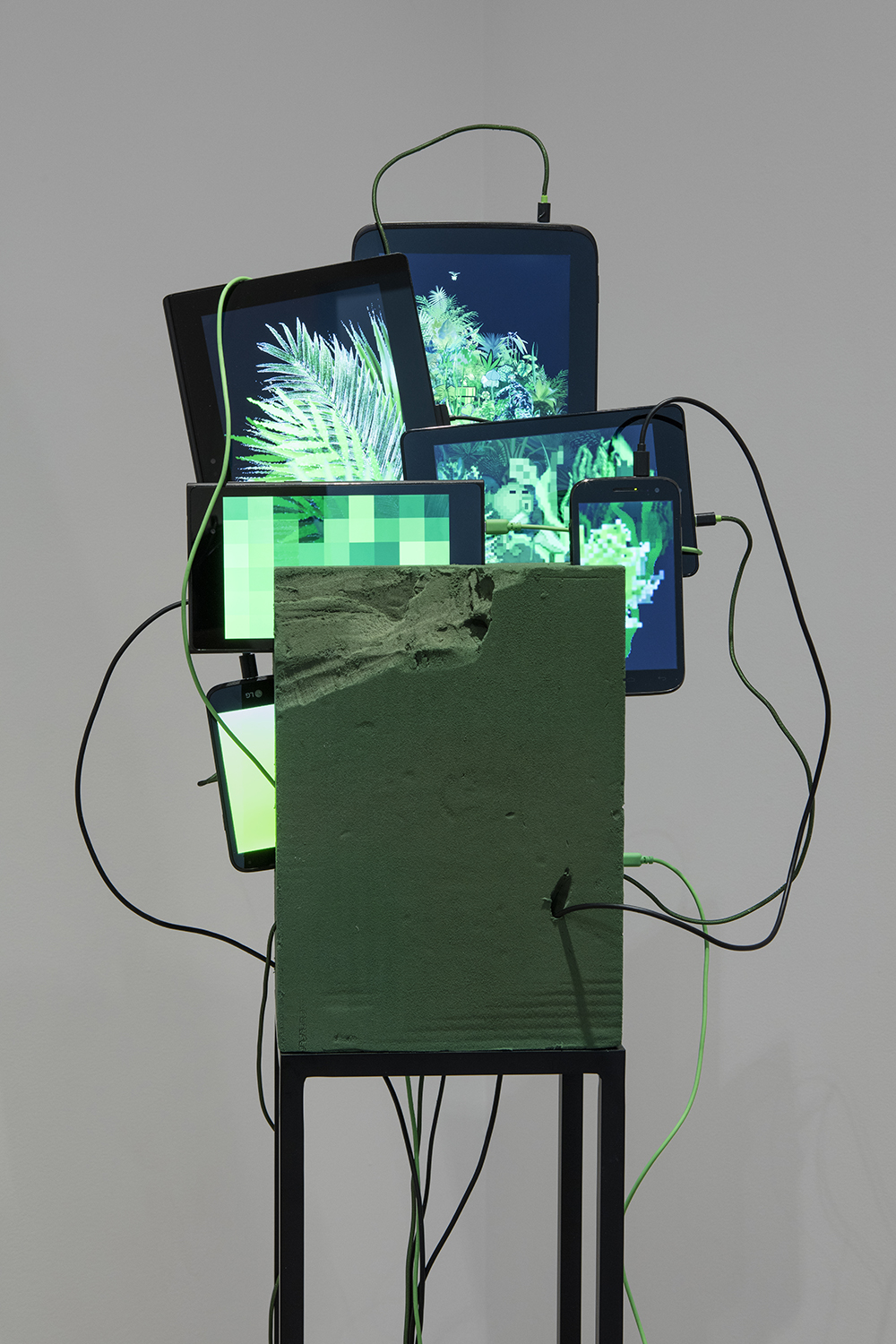 <em>Oasis Max Life</em>, 2016. Tablet computers in floral foam, steel pedestal, 59 x 15 3/4 x 15 3/4 inches