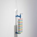 Mariana Murcia. <em>Save As 1</em>, 2017. Clamp, iPhone 5c cases and mirrors, 24 x 5 x 6 inches (61 x 12.7 x 15.2 cm)