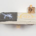 Kevin McNamee-Tweed.<em> Flight</em>, 2019. Ink, colored pencil, and acrylic on muslin mounted to wood with affixed felt and earplug, 8 x 14 3/4 x 6 1/2 inches (20.3 x 37.5 x 16.5 cm)