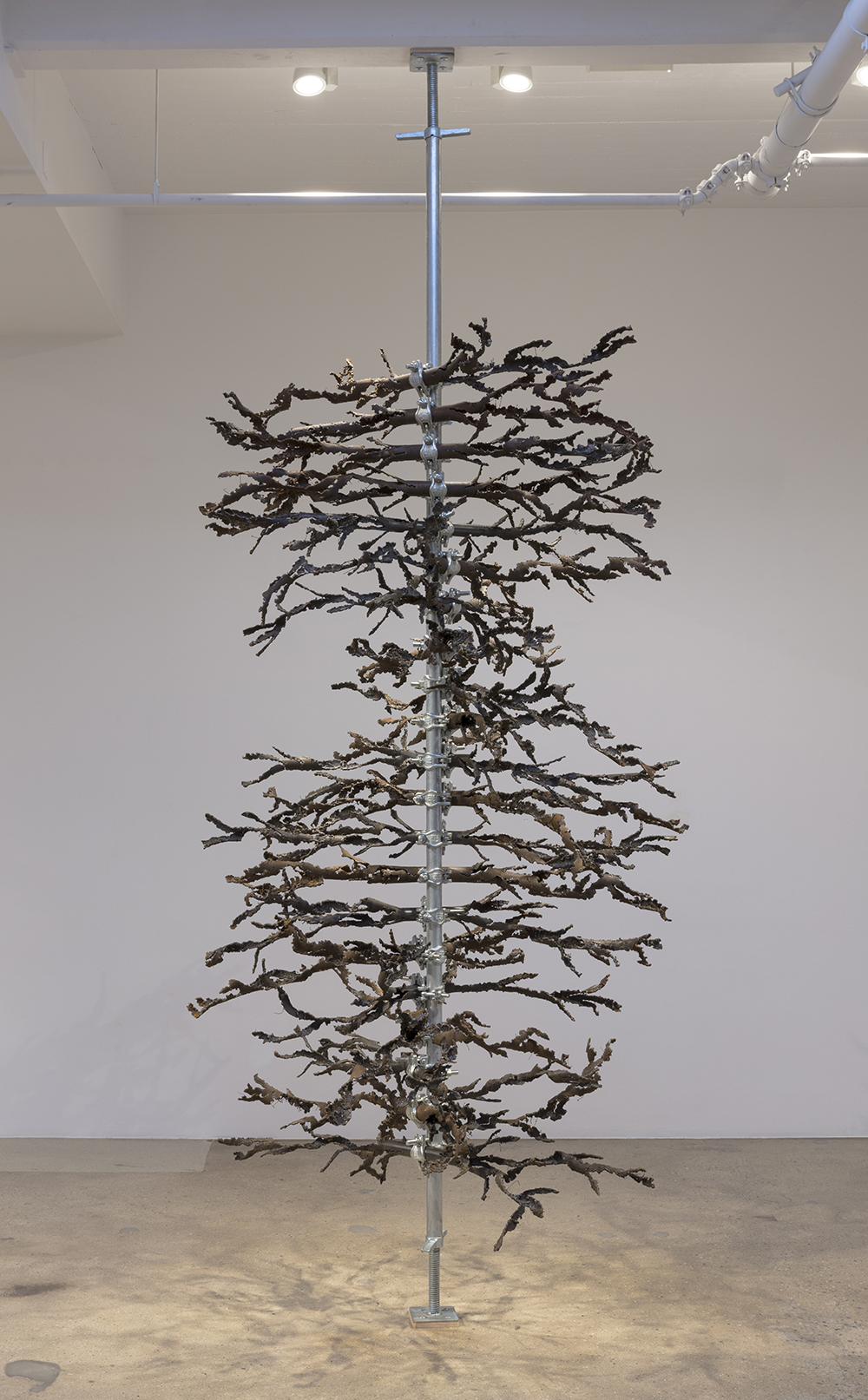 Luciana Lamothe. <em> Air Burn</em>, 2019. Iron pipes and clamps, 128 x 60 x 60 inches (325.1 x 152.4 x 152.4 cm)