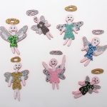 Benjamin Cabral. <em>Angel (Memories)</em>, 2021. Rhinestones and faux pearls on acrylic painted wood, Dimensions variable, each work ranges from 14 1/2–18 1/2 inches in height and 8–12 inches in width