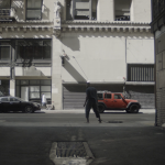 <em>Al abrigo del viento</em>, Still from documentation video of performance, Steve Turner, 2022. “During several hours, I walk barefoot through Downtown Los Angeles towards Skid Row, dragging a shackle chained to an iron carving of the word LIBERTAD (freedom).”