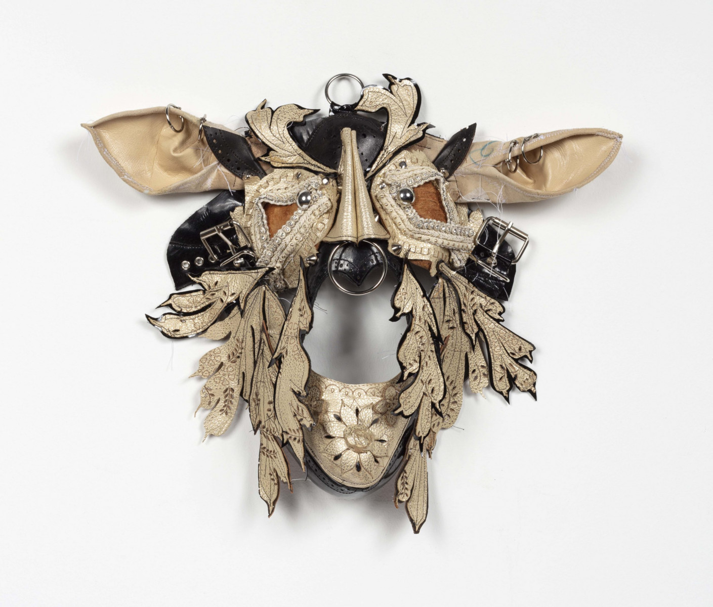 Jakob Rowlinson. <em>Mask VIII (Endymion Turned)</em>, 2023. Punched leather, buckles, rings, studs, eyelets and trimmings, 12 x 15 x 3 7/8 inches (30.5 x 38.1 x 9.8 cm)