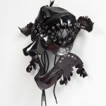 Jakob Rowlinson. <em>Mask XII (Appellant Fawn)</em>, 2023. Patent leather, shoelaces, eyelets, split pins and clip rings, 12 x 15 x 6 3/4 inches (30.5 x 38.1 x 17.1 cm)
