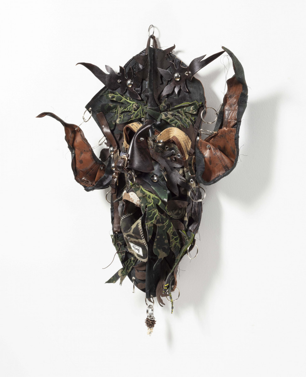 Jakob Rowlinson. <em>Mask XVI (Taurus)</em>, 2023. Leather boots, viscose shoes, cotton embroidery, boot buckle, rings, waxed cotton thread, split pins, canvas All-stars shoes, rivets, safety pins, rings, goat's tooth, sweet gum ball, piercings and screws, 27 x 23 x 5 1/2 inches (68.6 x 58.4 x 14 cm)